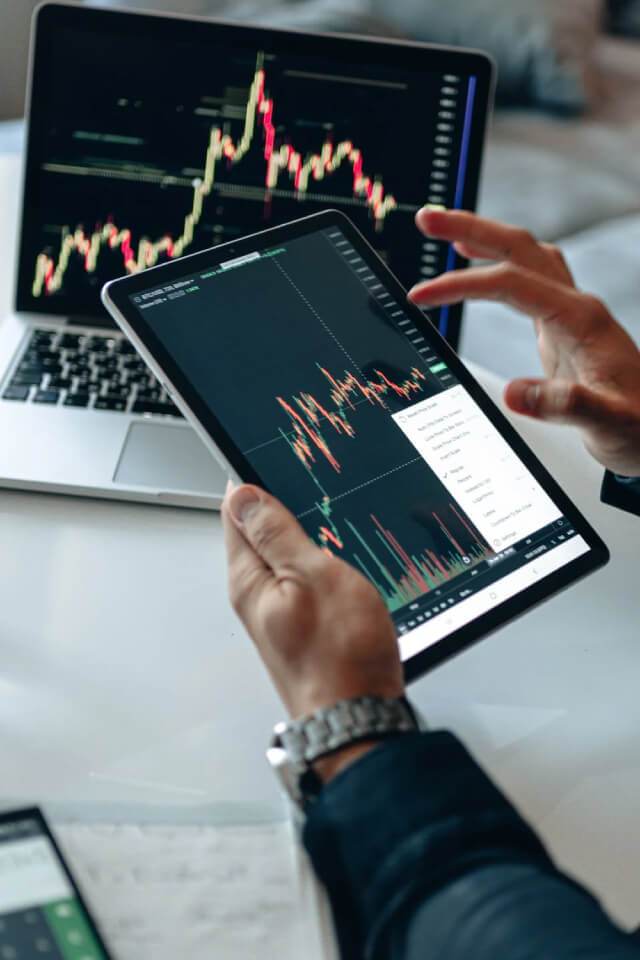 SEO Audits for ecommerce - a person looks at data graphs on a laptop and a tablet